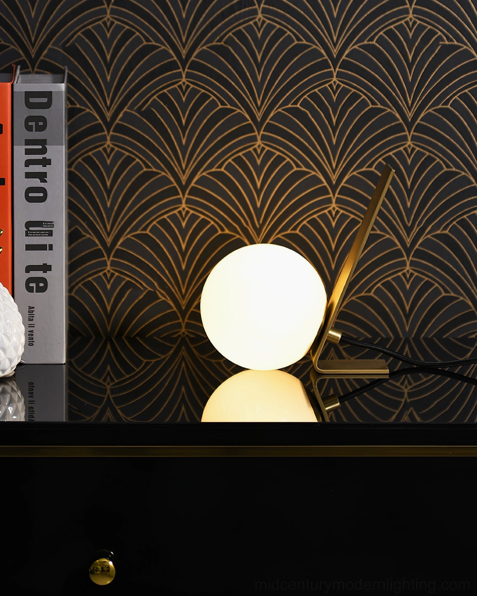 Daphne decorative table lamp on luxury cabinet surface with design books and art deco wallpaper