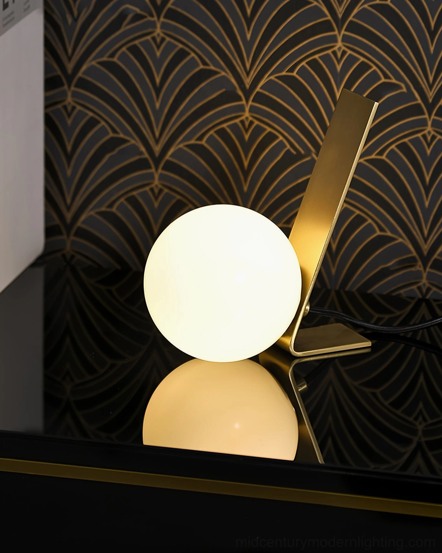 Daphne table lamp close-up on black countertop with art deco backdrop and surface reflection