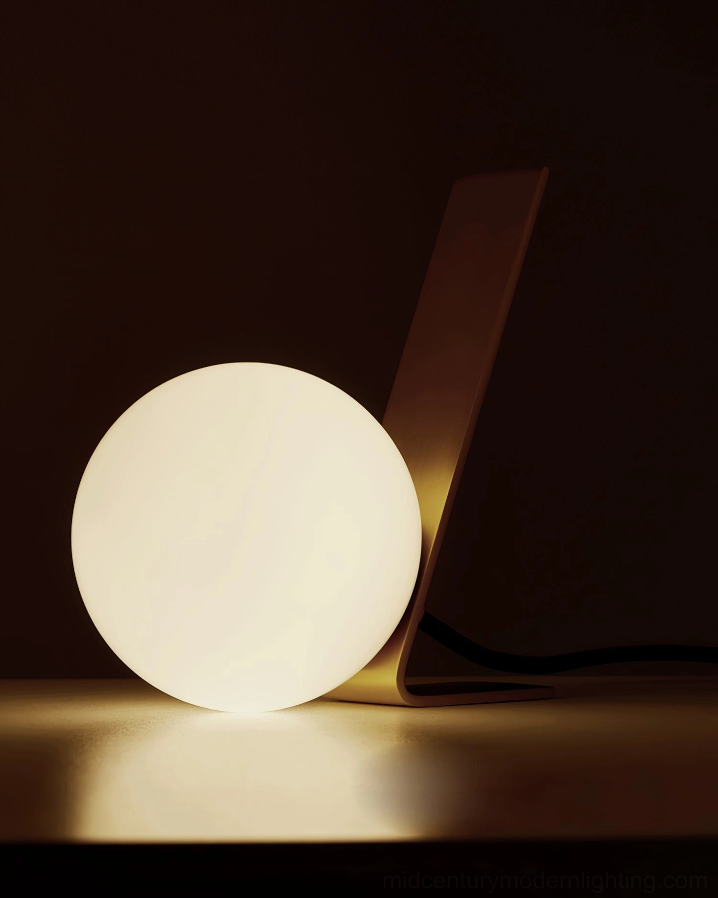 Daphne unlit table lamp showing frosted glass orb and brushed brass base on warm tabletop