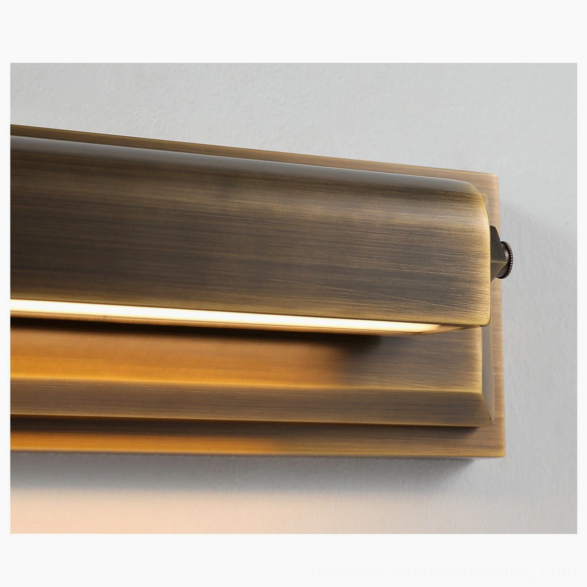 Davenport tiered wall sconce detail view, antique brass stepped backplate with integrated warm white LED warm light technology