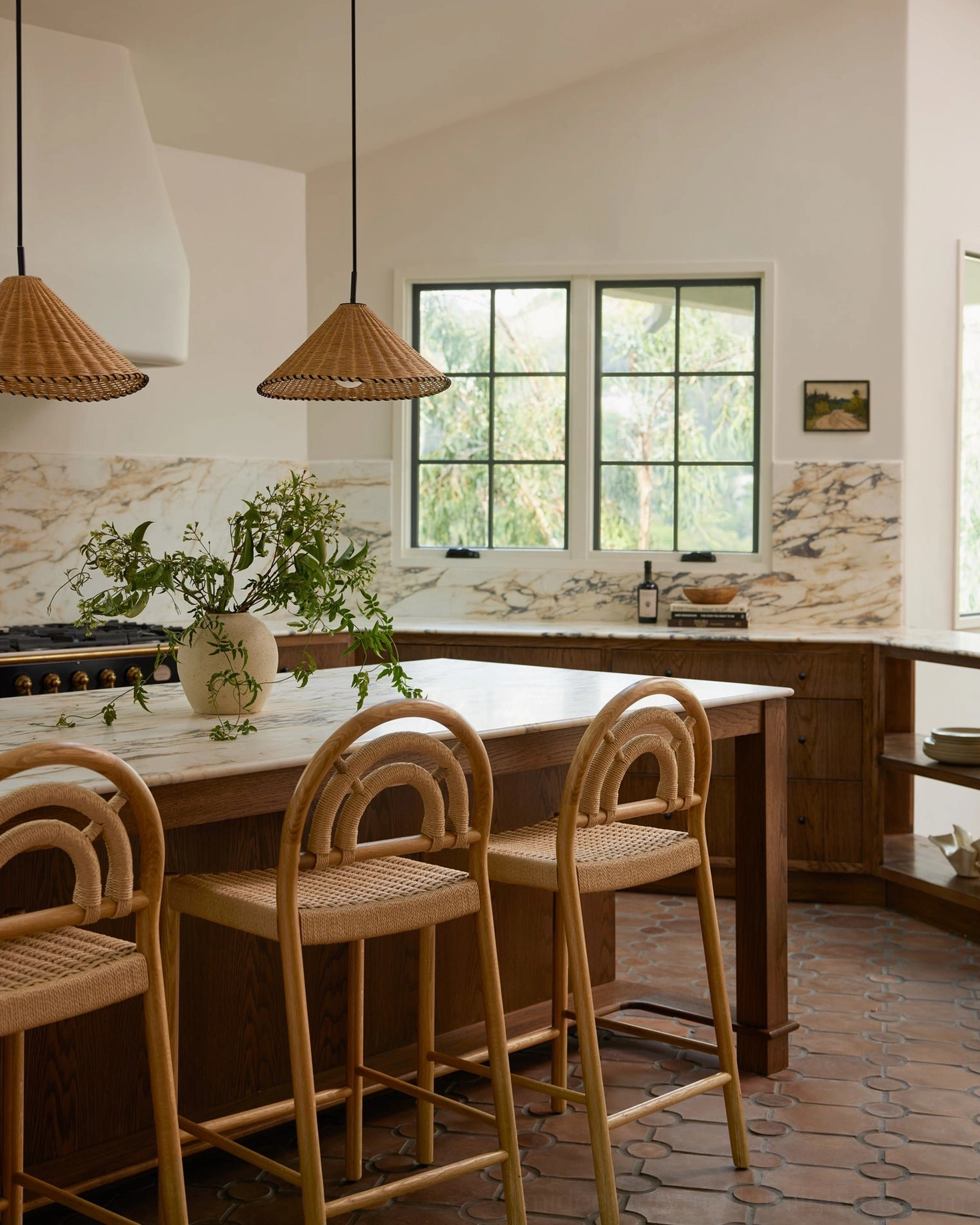 Two natural rattan pendant lights over kitchen island, modern rustic kitchen style with warm neutral décor