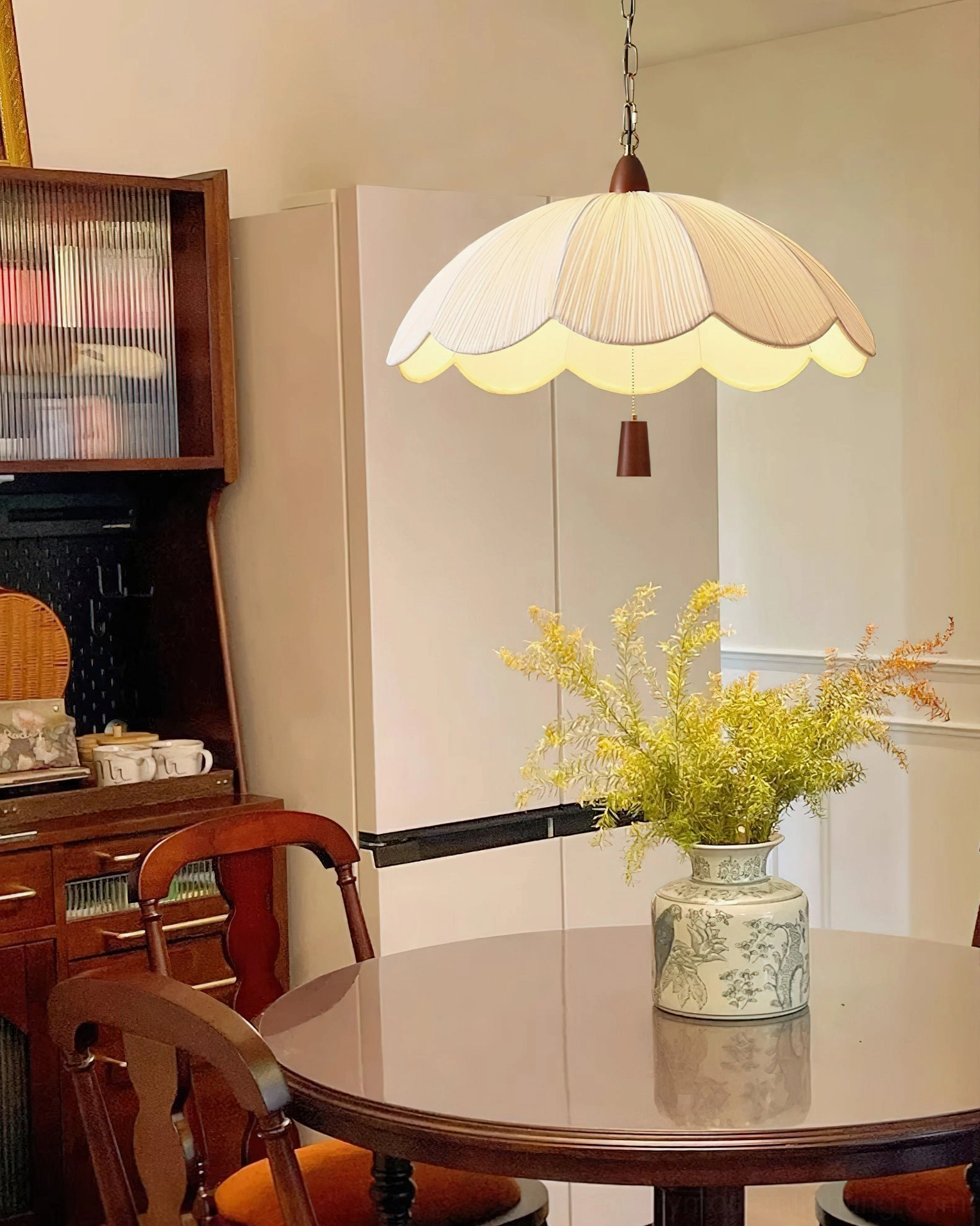 Vintage-style pendant light in kitchen dining area with wooden cabinetry and neutral tones