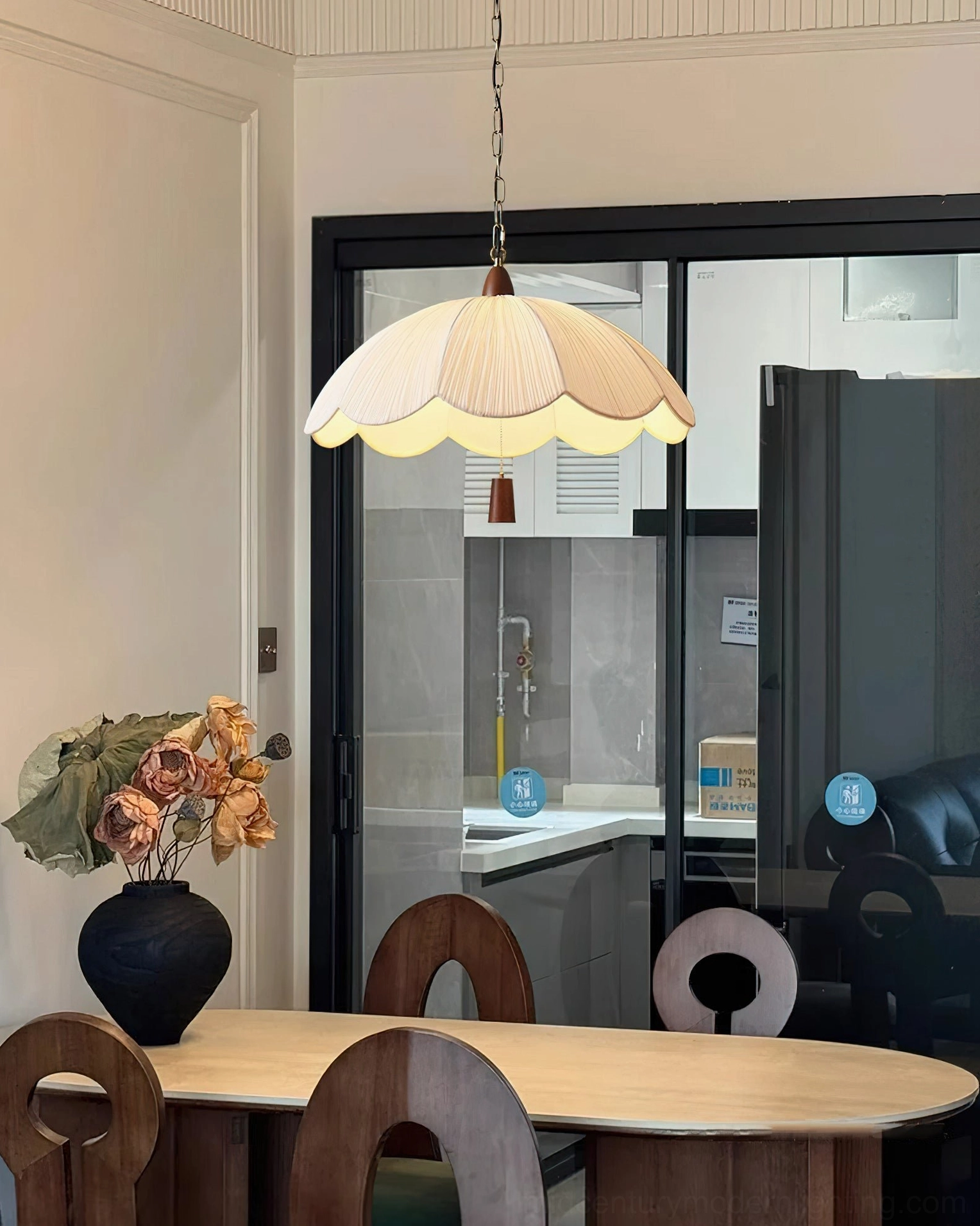 Scalloped fabric shade pendant light casting diffused glow in mid-century modern kitchen setting