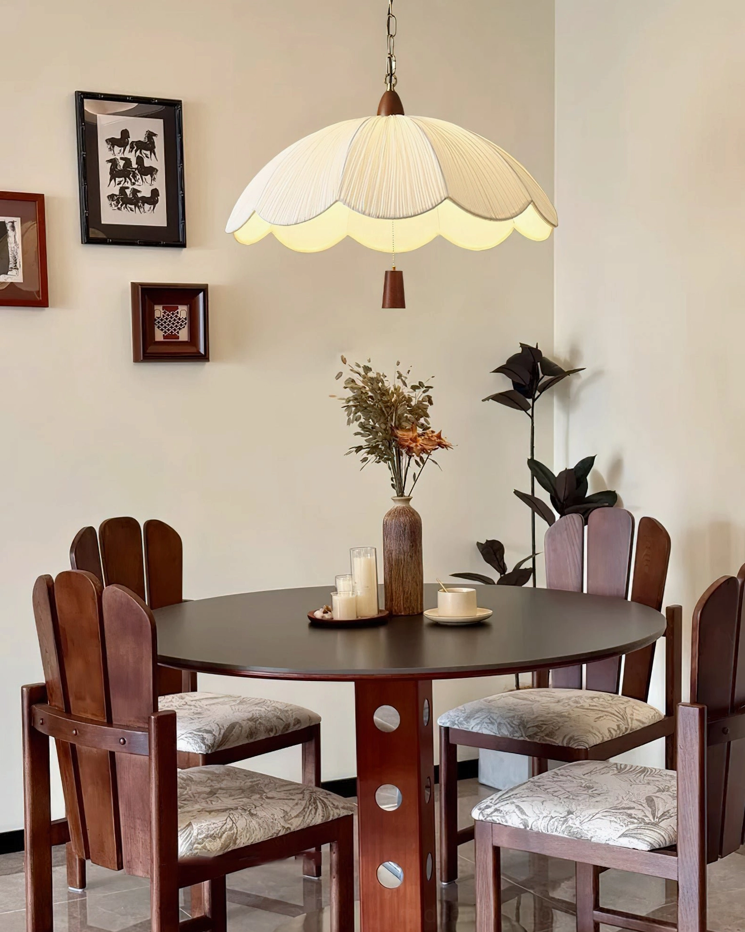 Retro scalloped pendant light above dining area with formal room decor and wall art