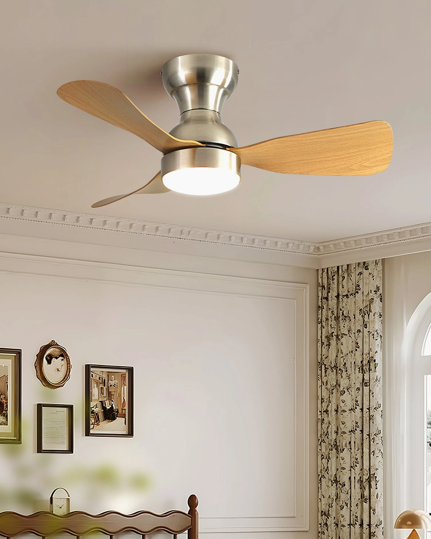 Minimalist bedroom with arched windows featuring installed ceiling fan light with light wood blades, warm neutral décor and classic architectural details