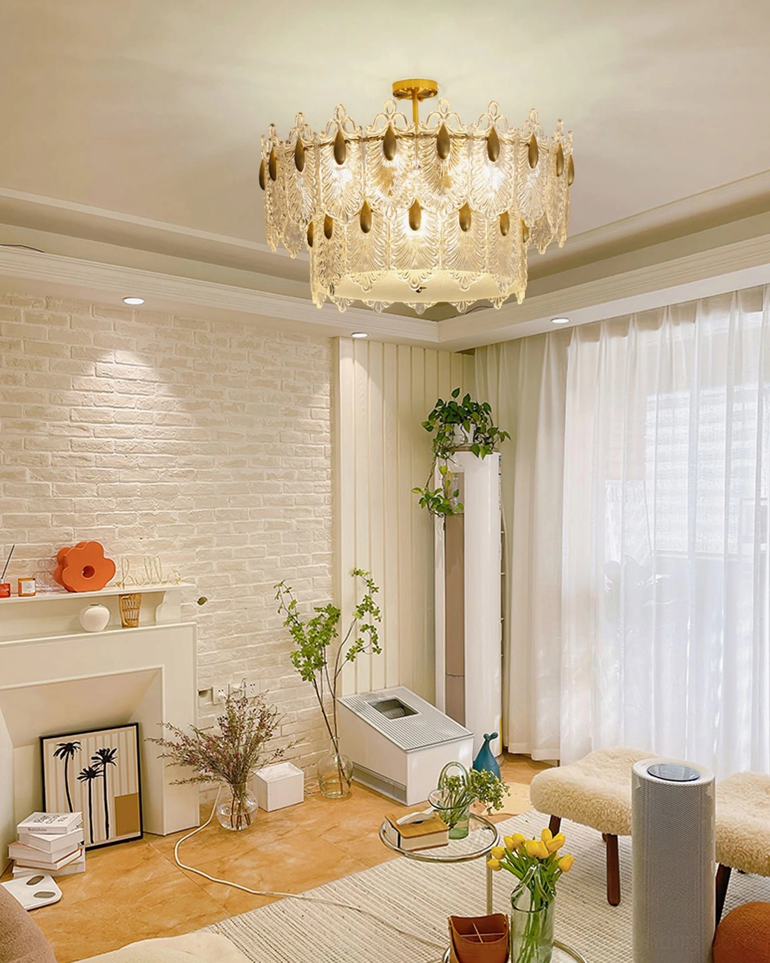Family room Decazes chandelier, cozy modern living space with brick accent wall, sheer curtains, warm ambient light, greenery