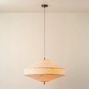 Delaney pendant lamp hanging indoors, warm ambient lighting from linen shade, eye-level view