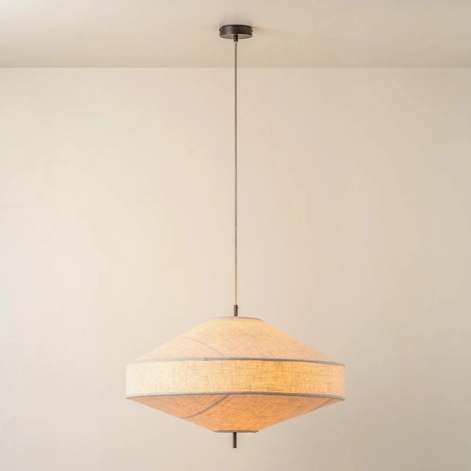 Delaney pendant lamp hanging indoors, warm ambient lighting from linen shade, eye-level view