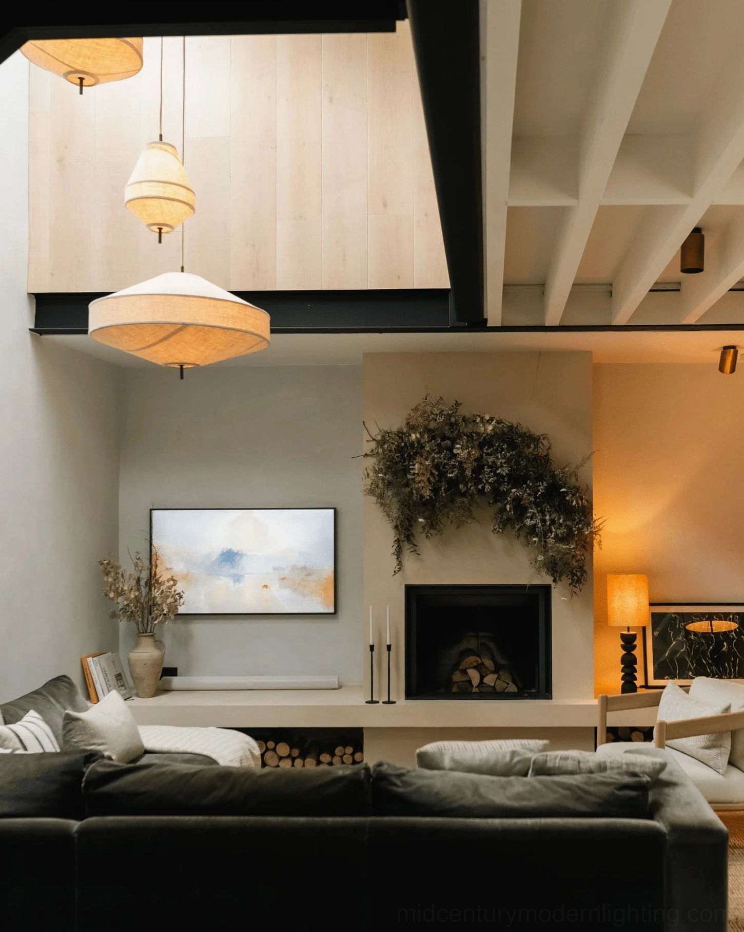 Multiple Delaney pendant lights in modern living room with fireplace, warm ambient home lighting