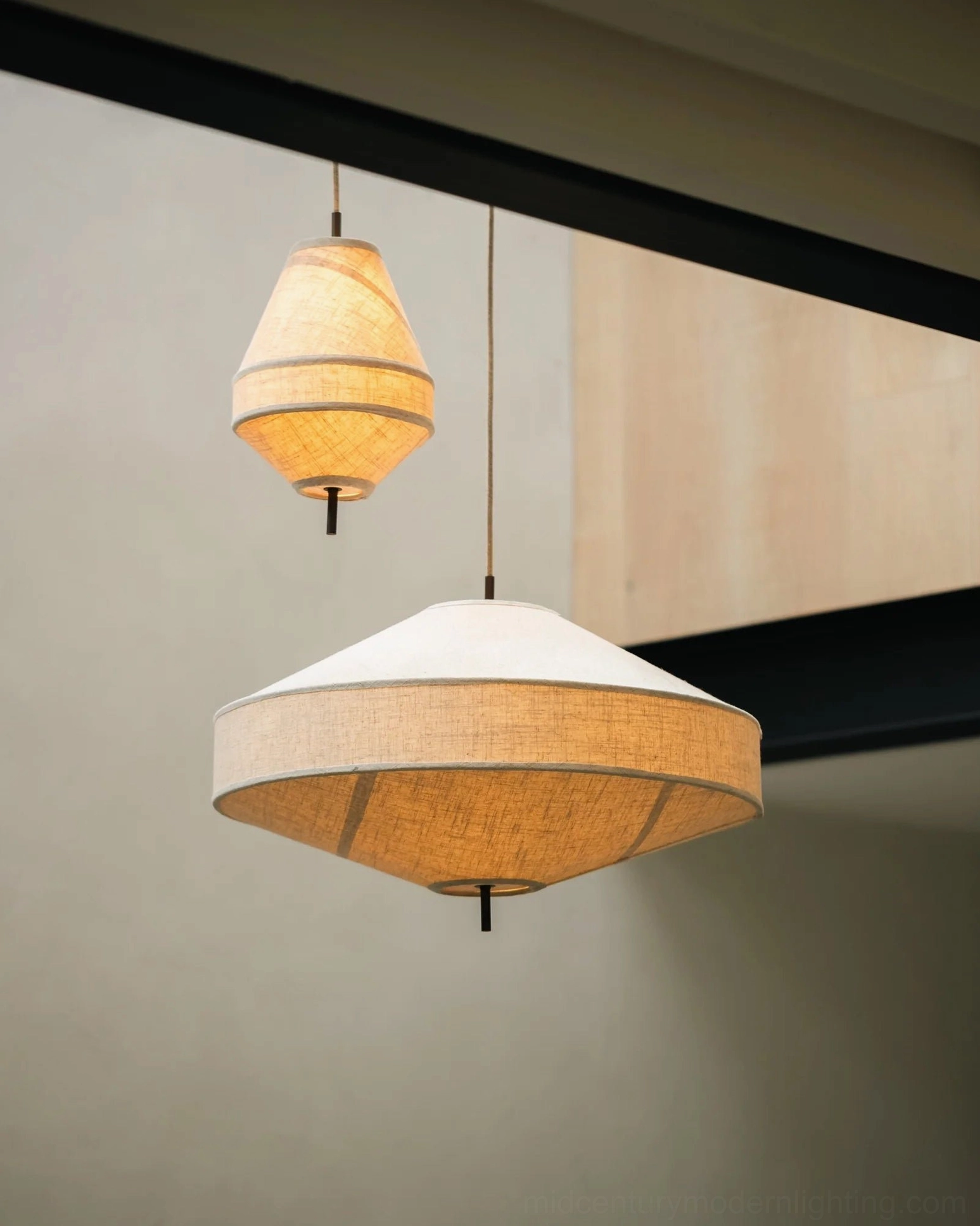Two Delaney pendant lights in different sizes installed together, low angle view, modern entryway setting