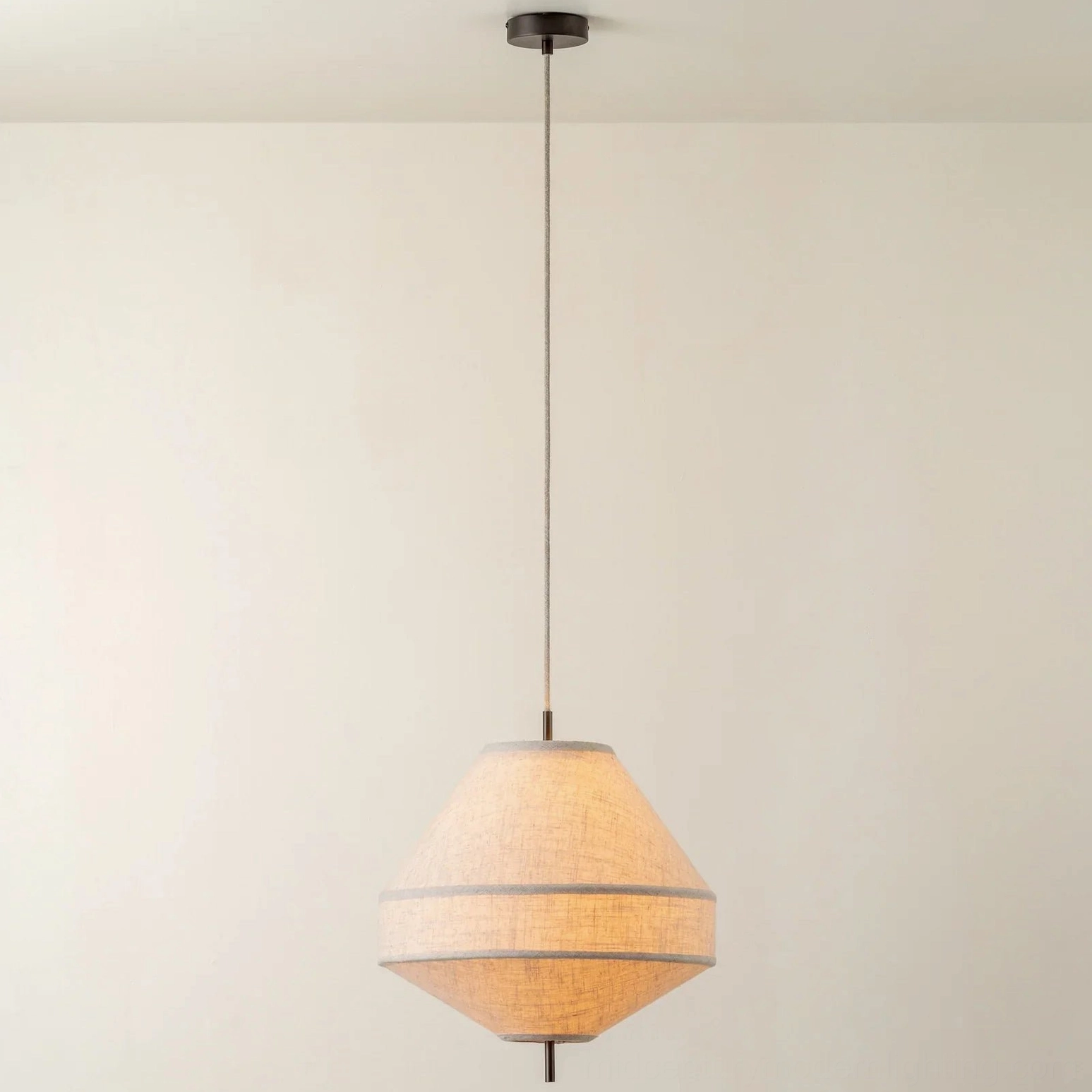 Delaney tapered fabric pendant with warm glowing linen, eye-level frontal view, minimalist aesthetic