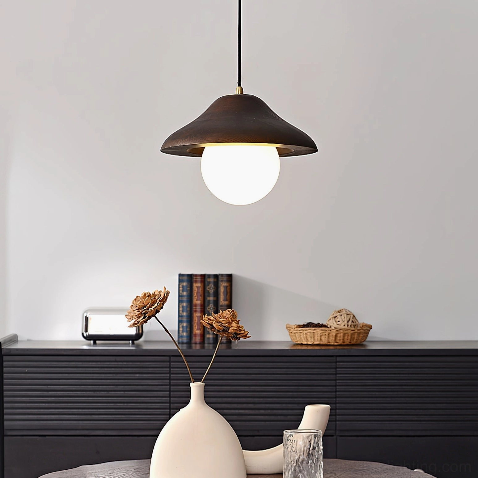 Close-up frontal view of Delano pendant light showing wood dome shade and glowing frosted white glass bulb diffuser