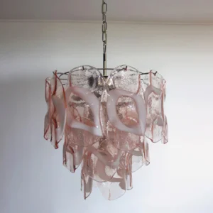 Close-up of Delara pink glass chandelier with metal hanging chain, displaying handcrafted glass texture and layered petal structure