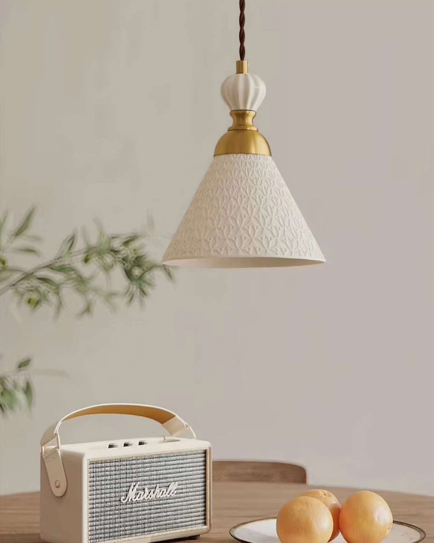 White ceramic handmade pendant lamp with delicate silhouette and warm ambient light