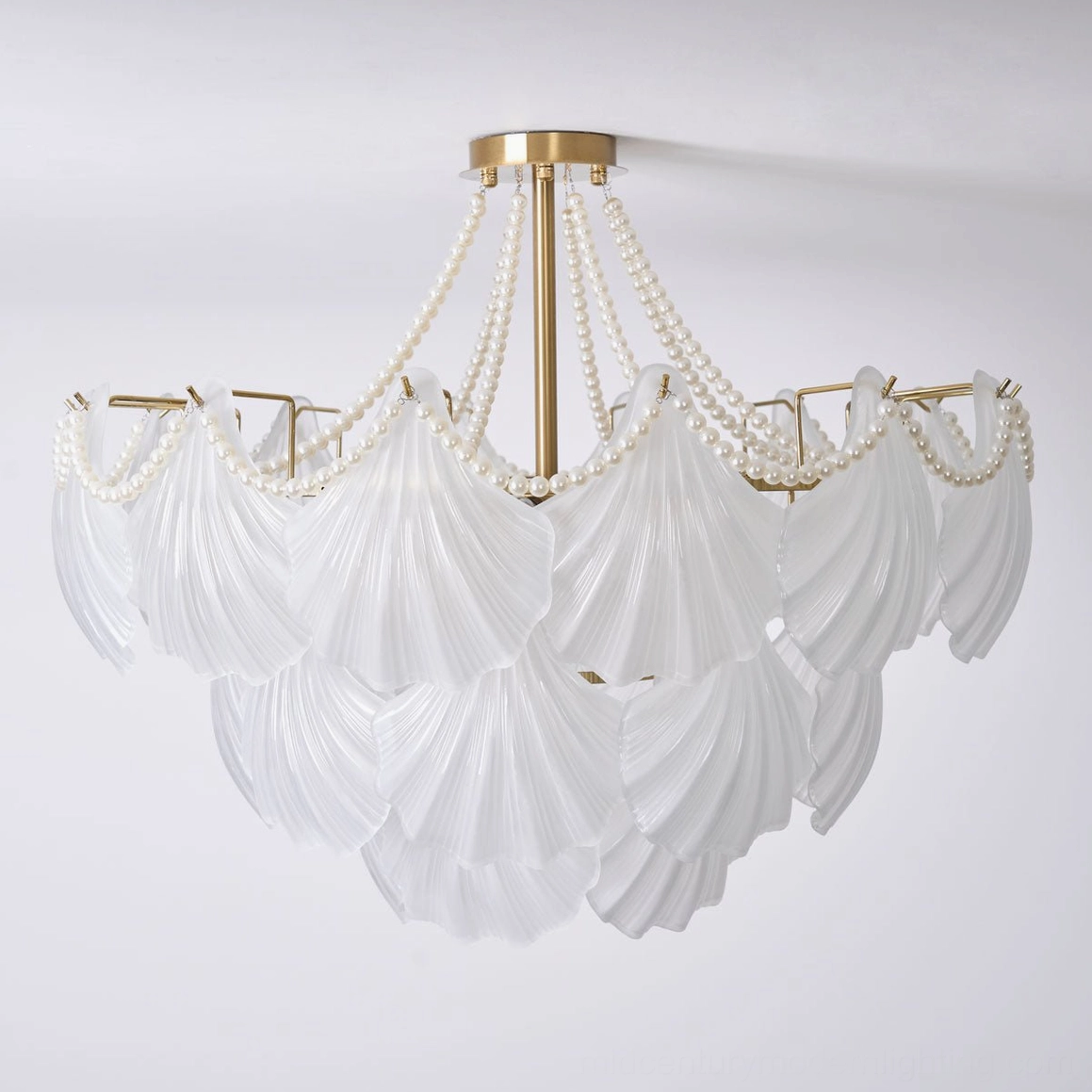 Designer scallop shell chandelier with luxury glass elements and refined brass metalwork detail shot