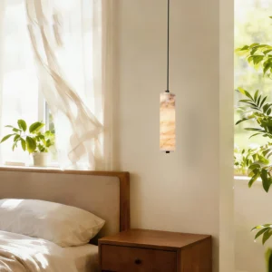 Single Devane alabaster pendant light in warm bedroom interior with nightstand, natural wood furnishings, and green plants, demonstrating bedside accent lighting