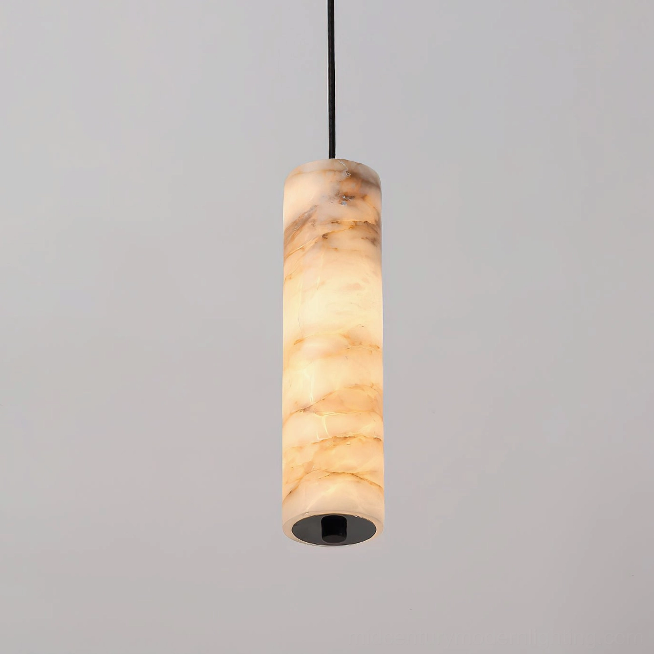Front view of Devane alabaster pendant light showing slender cylindrical shape, open bottom design, and smooth alabaster stone surface texture