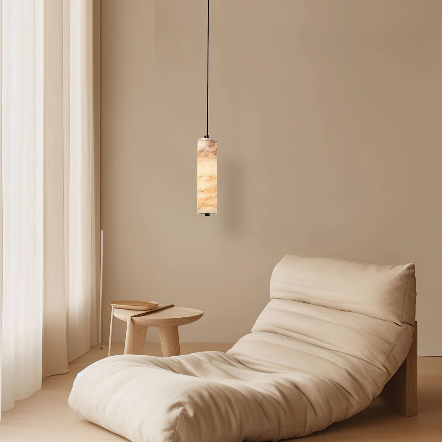 Single Devane alabaster pendant light in lounge area with daybed and sheer curtains, showing warm diffused glow through stone material