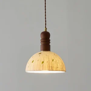 Close-up of Diana pendant light dome shade showing delicate leaf inclusions and turned wooden mounting fixture