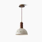 Diana handcrafted paper pendant light with leaf motifs, brass hardware, and walnut wood fixture in studio overhead view