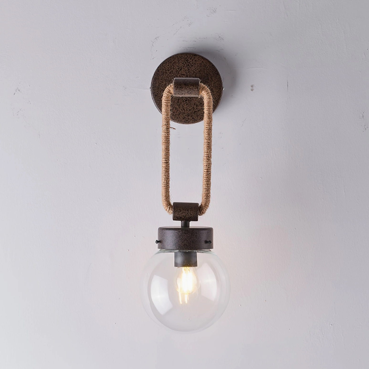 Dillon wall lamp with illuminated Edison-style filament bulb creating vintage ambiance on interior wall
