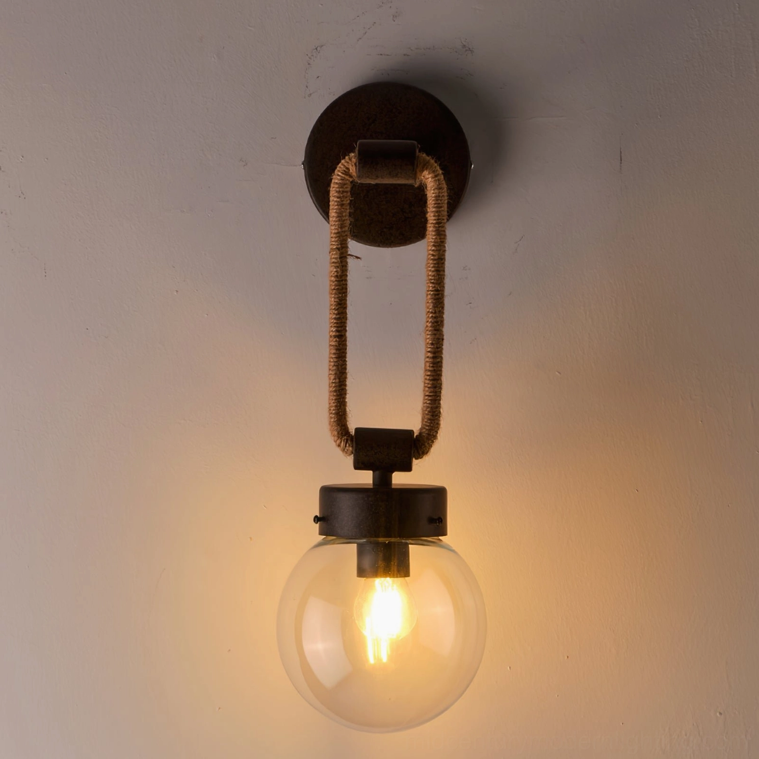 Close-up detail of Dillon lamp showing twisted hemp rope loop and aged dark brown antique metal finish