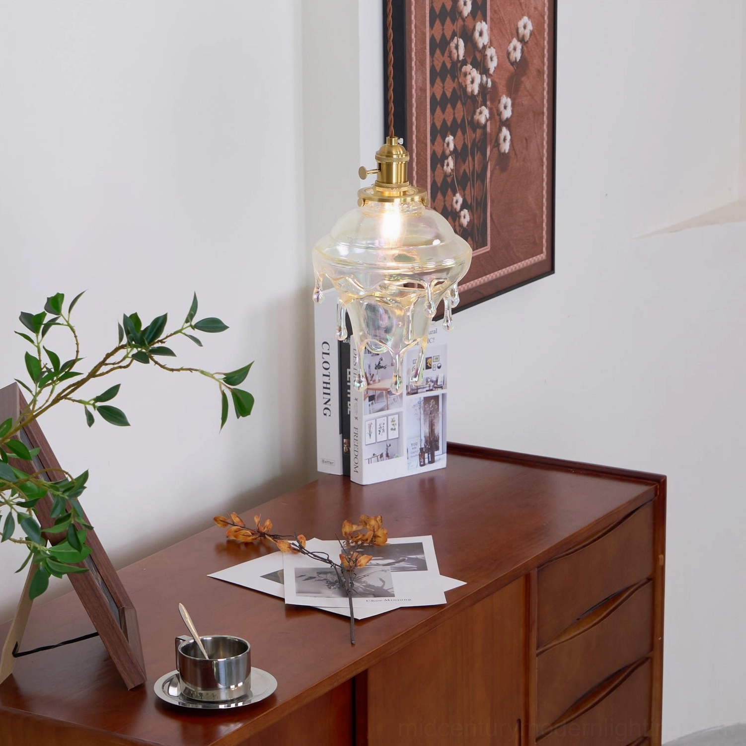 Water droplets resin pendant lamp positioned in dining room above table setting