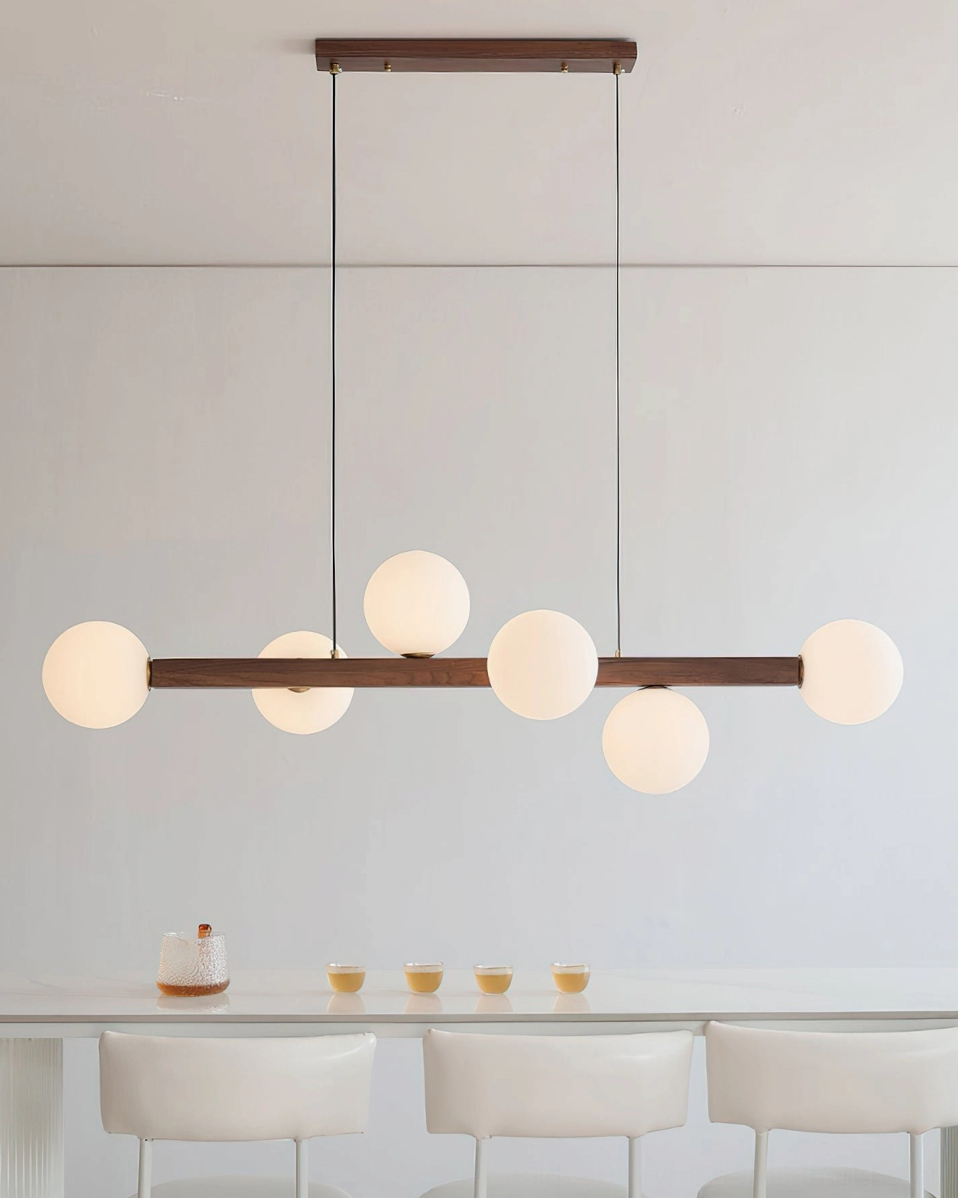 Dioniso wood and glass linear chandelier eye-level view minimalist dining studio