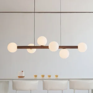 Dioniso walnut wood chandelier with glass globes illuminated in modern dining room setting