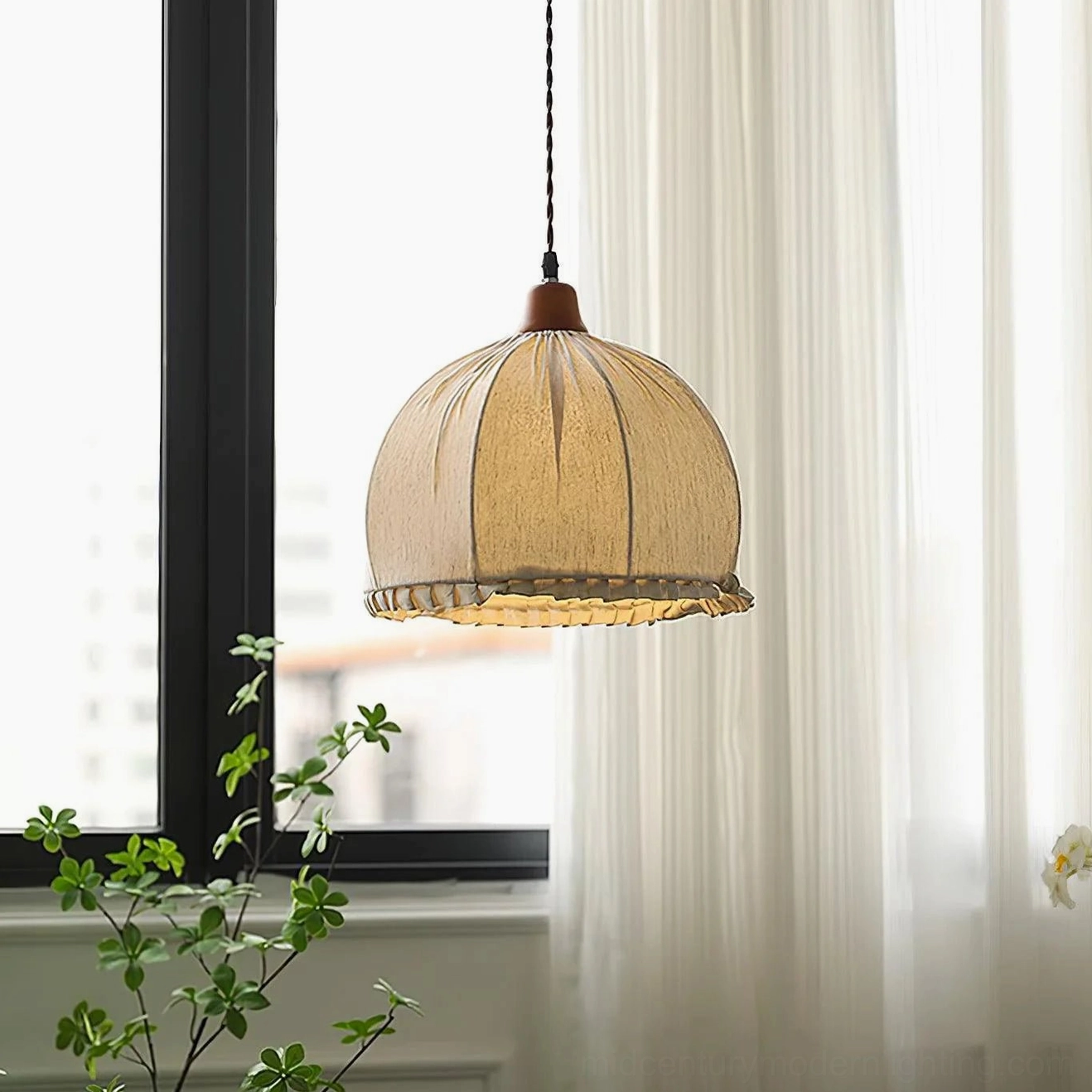 Dippa fabric pendant lamp hanging in modern interior with pleated linen shade and wooden cap above table