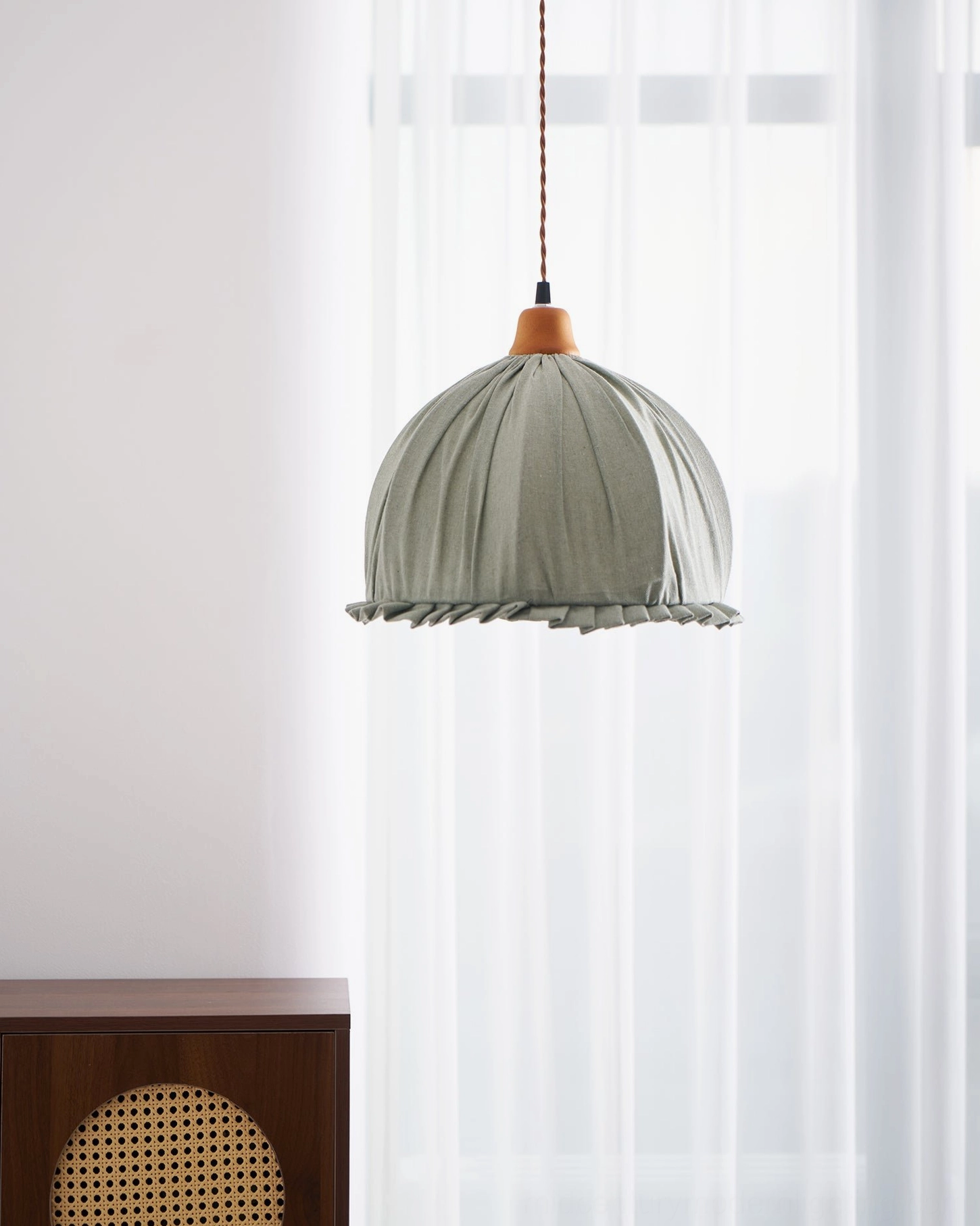 Dippa handcrafted pendant lamp sage green and walnut finish in studio setting