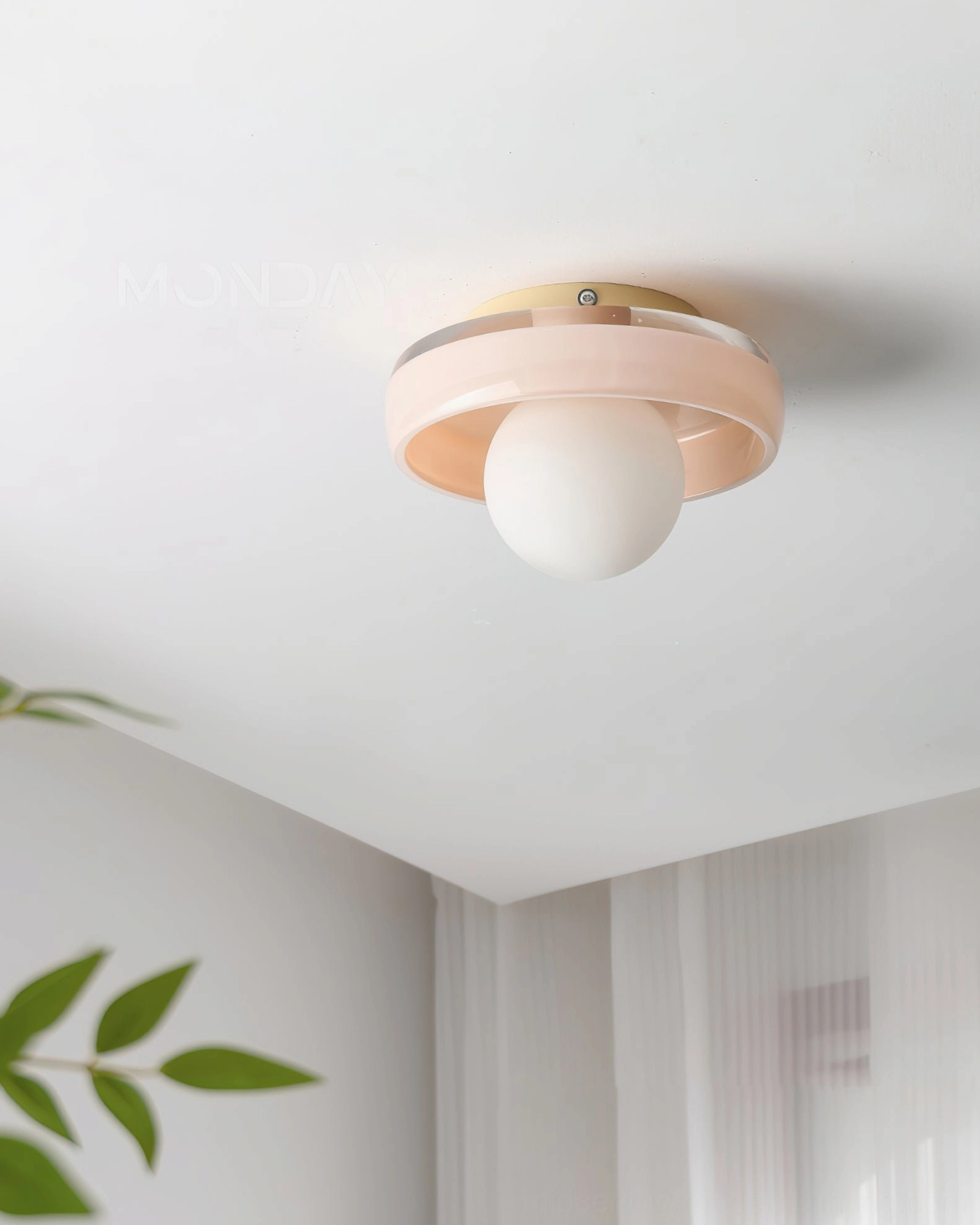 Pink frosted Disc Orb Ceiling Light installed in minimalist bedroom with potted green plant decor