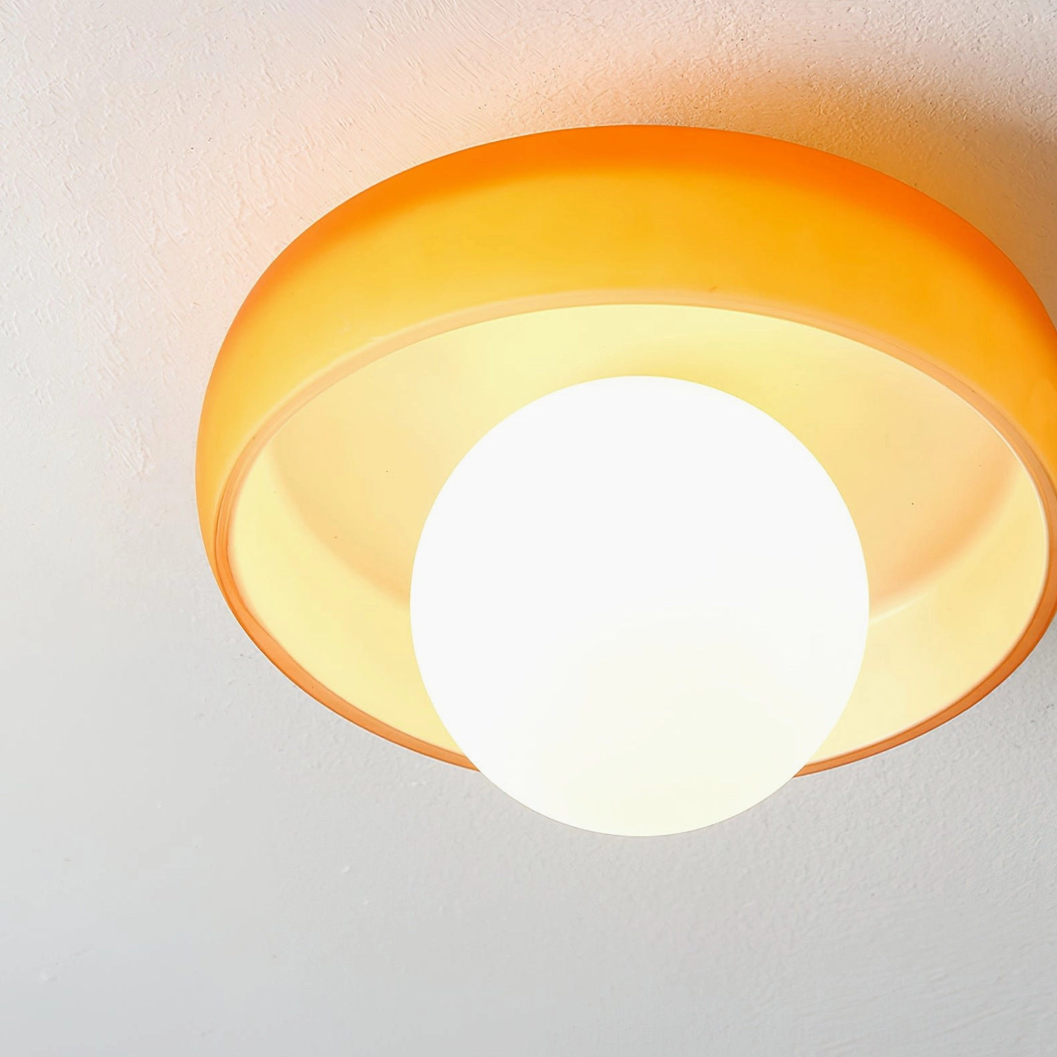 Pink Disc Orb Ceiling Light paired with home decor showing contemporary interior styling application
