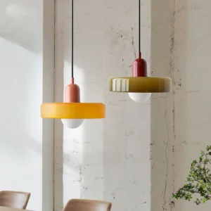 Two Disc Orb Pendant Lights in contrasting finishes hung above dining table in industrial space