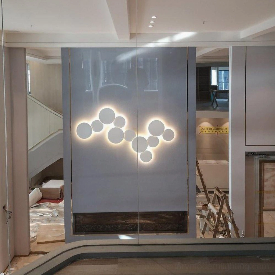 Modern disc wall sconce with multiple size configuration options for adaptable interior design installations