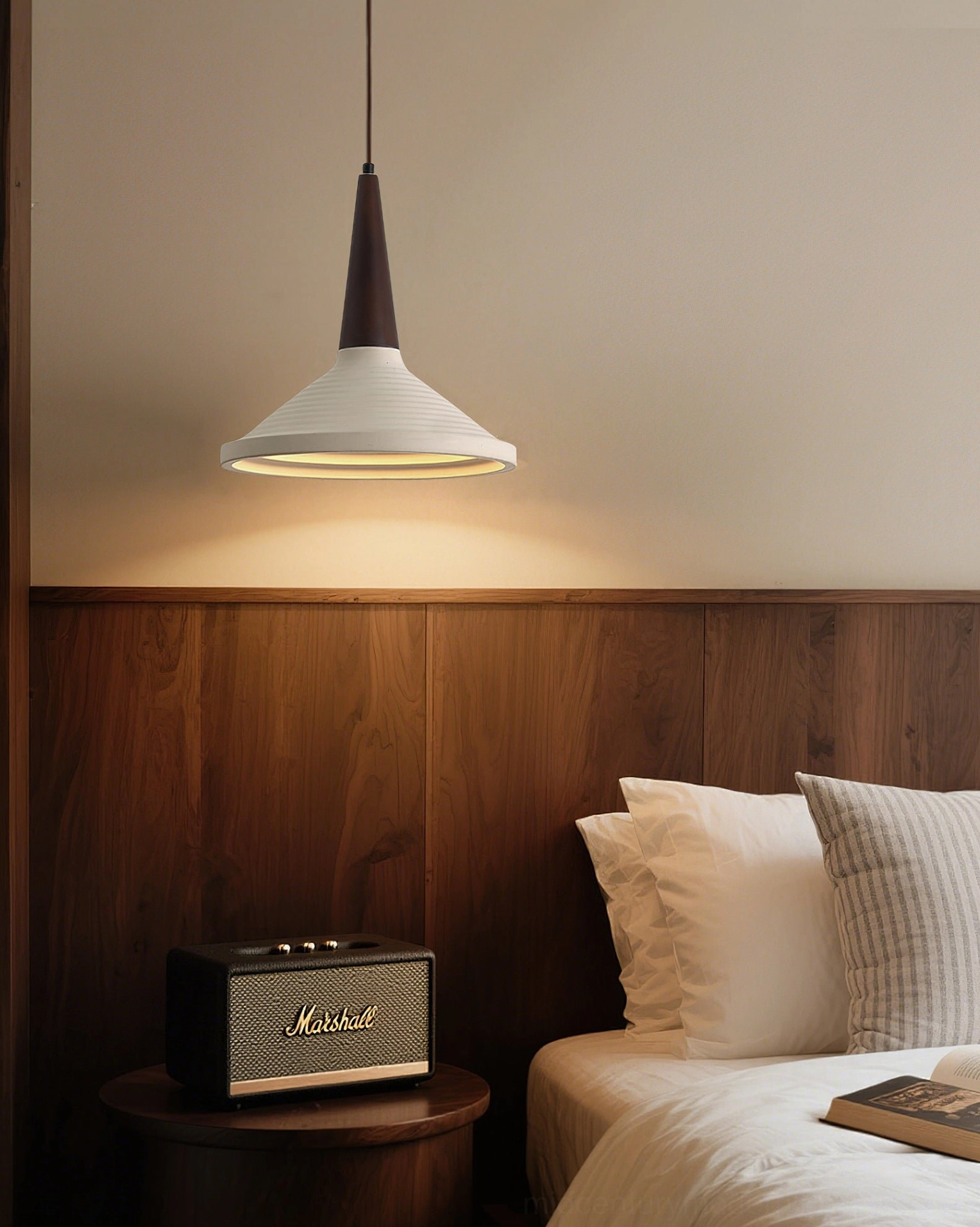 Doherty pendant light in warm minimalist bedroom, accenting walnut headboard decor