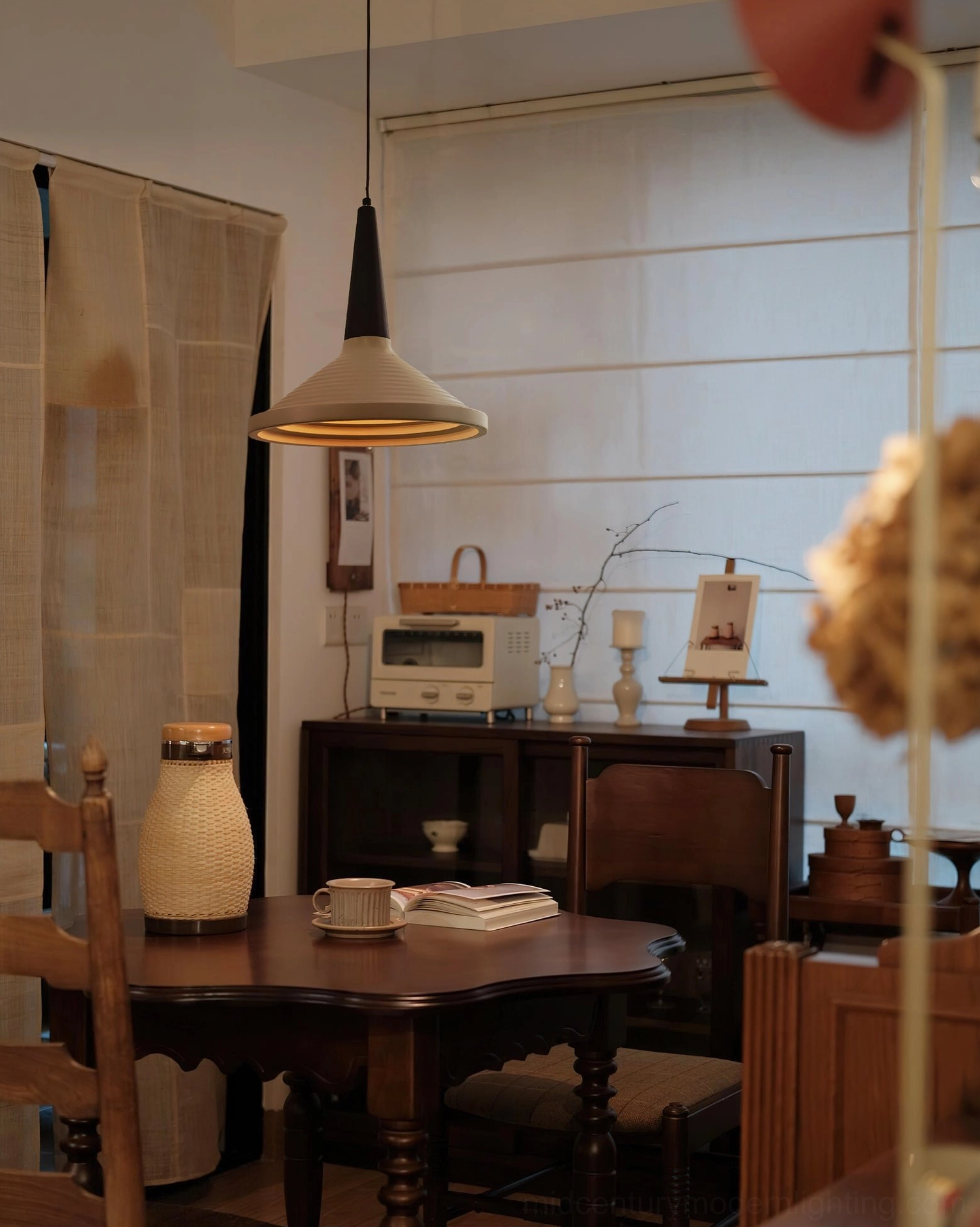 Single Doherty pendant light in cozy vintage dining nook, warm wooden home decor