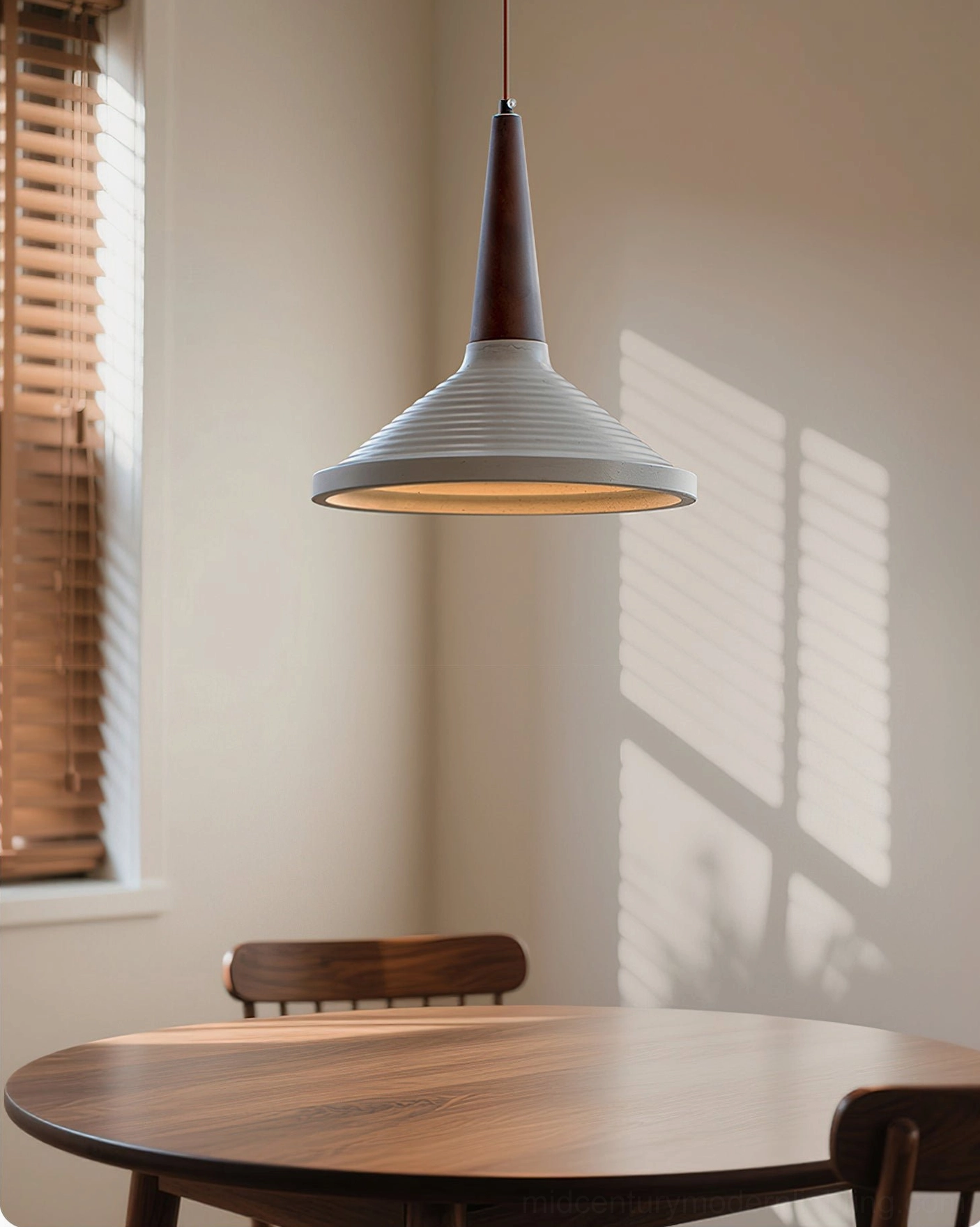 Single Doherty pendant light suspended over wooden dining nook by window, minimalist retro style