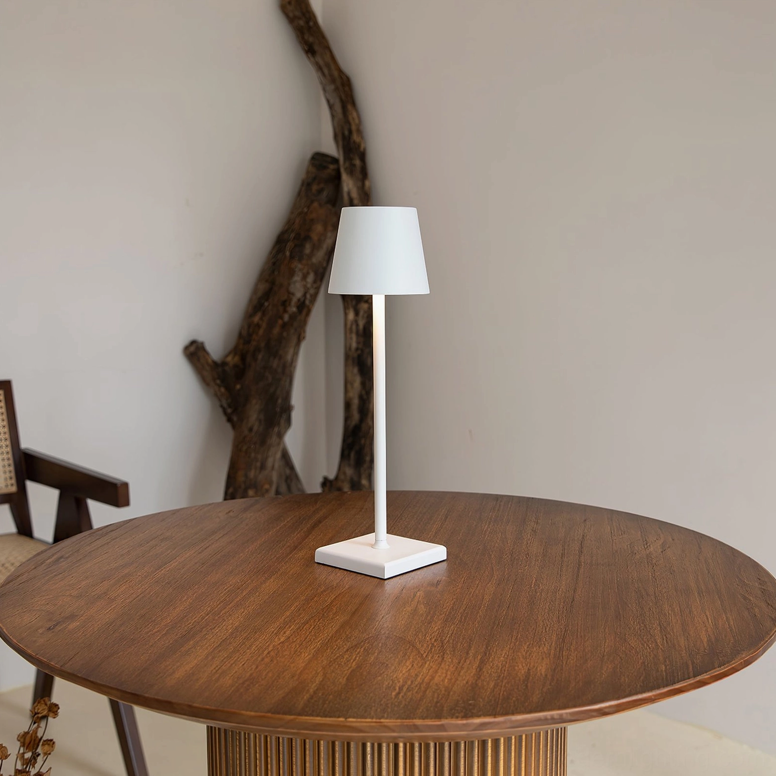 Doku portable table lamp placed in eclectic bohemian interior with plants and textiles