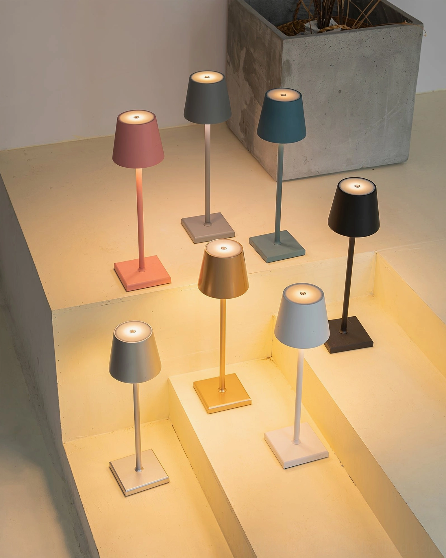Doku portable lamp showing compact size comparison with other tabletop objects