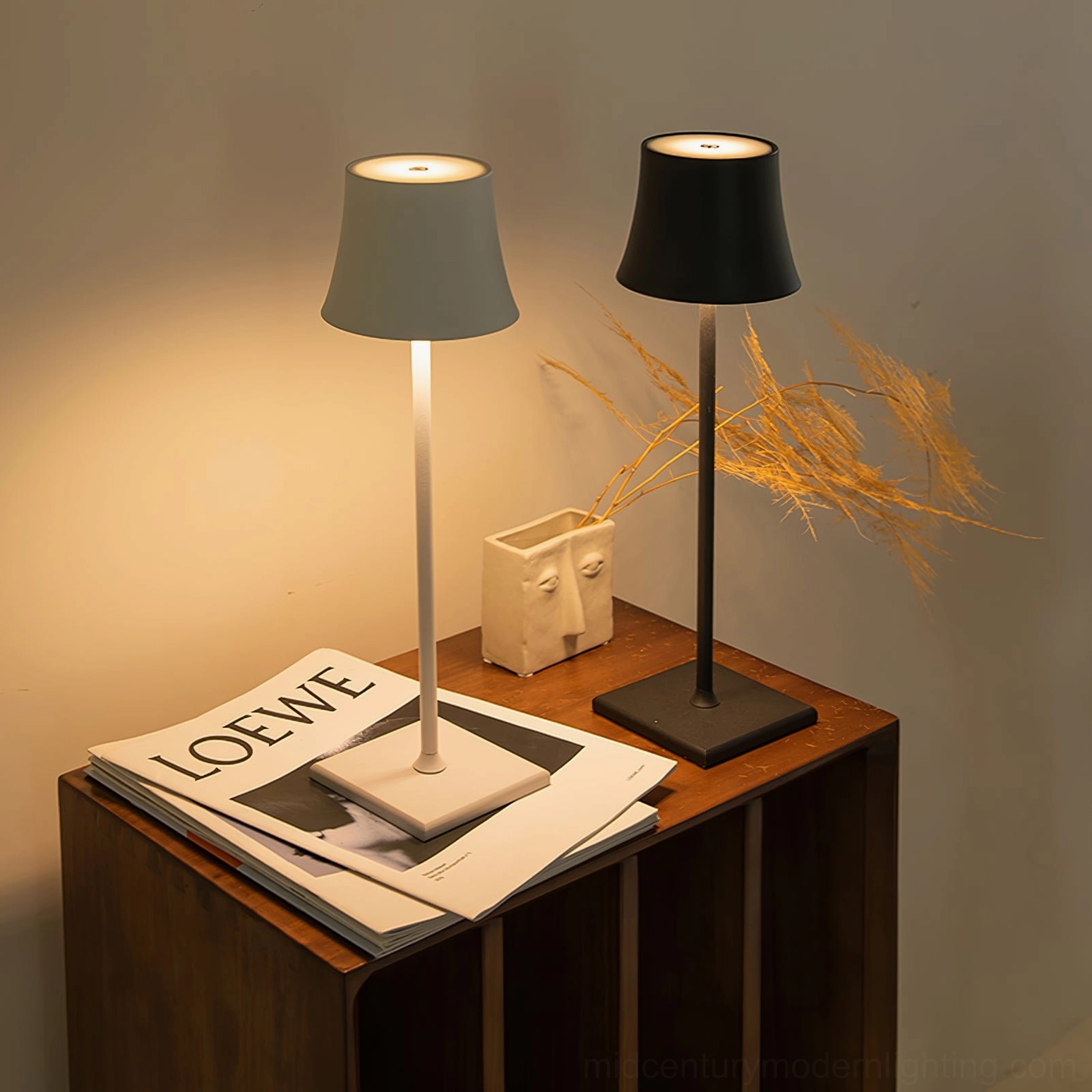 Two Doku portable lamps in different finishes on modern home side table with wooden furniture