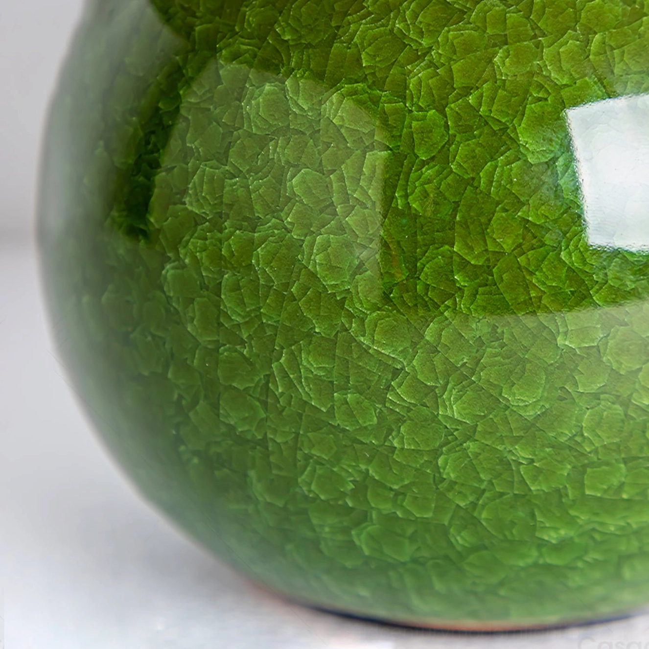Close-up detail of Dolly lamp ceramic base showing crackle glaze texture and hand-glazed olive green finish