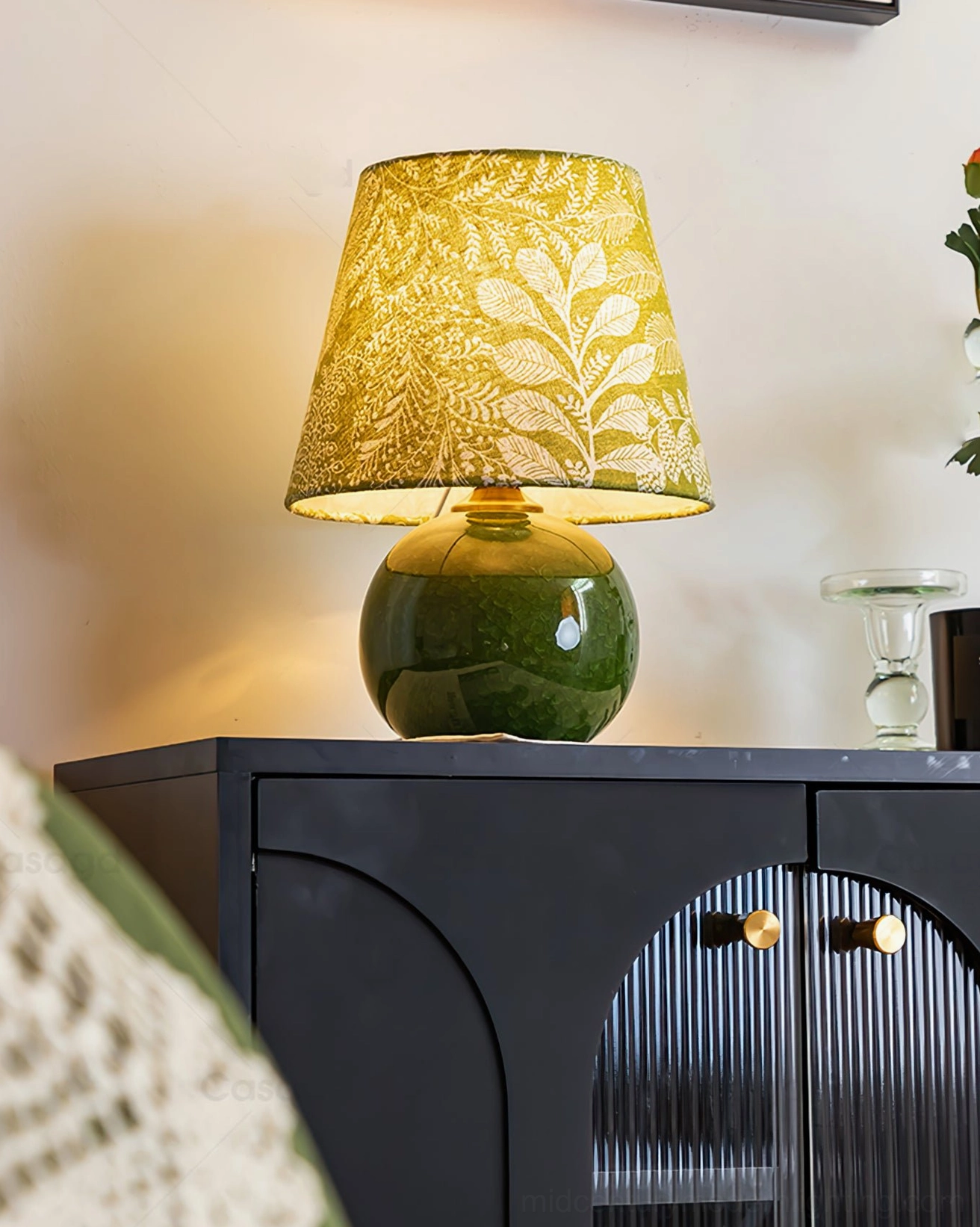 Dolly table lamp illuminated in modern living room with black console cabinet, warm ambient light