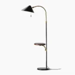 Dominique arc floor lamp with black marble base and brass accents, full front studio view showing sculptural design
