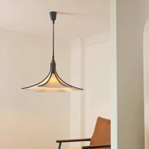 Mid-century modern pendant light in minimalist living room setting, three-quarter angle view showing fabric diffuser