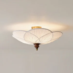 Large 65cm diameter Doral ceiling light illuminated overhead, warm ambient lighting with brass accents in minimalist interior