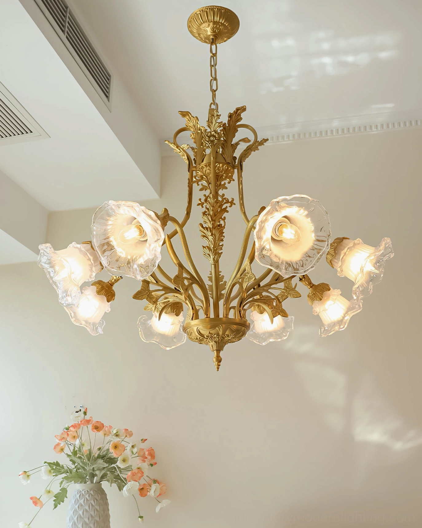 Eight-head Dore brass flower chandelier illuminated in corner setting with coordinated floral decor