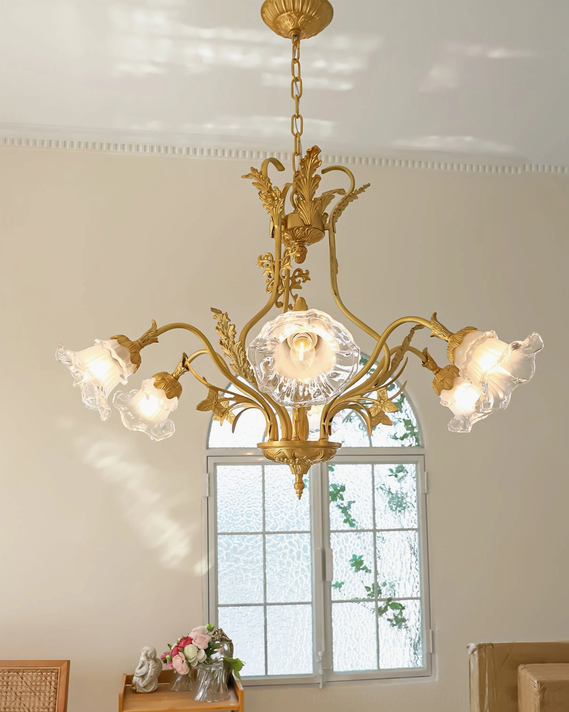 Vintage-inspired Dore flower chandelier with lit Edison-style bulbs and elaborate brass frame in French salon setting
