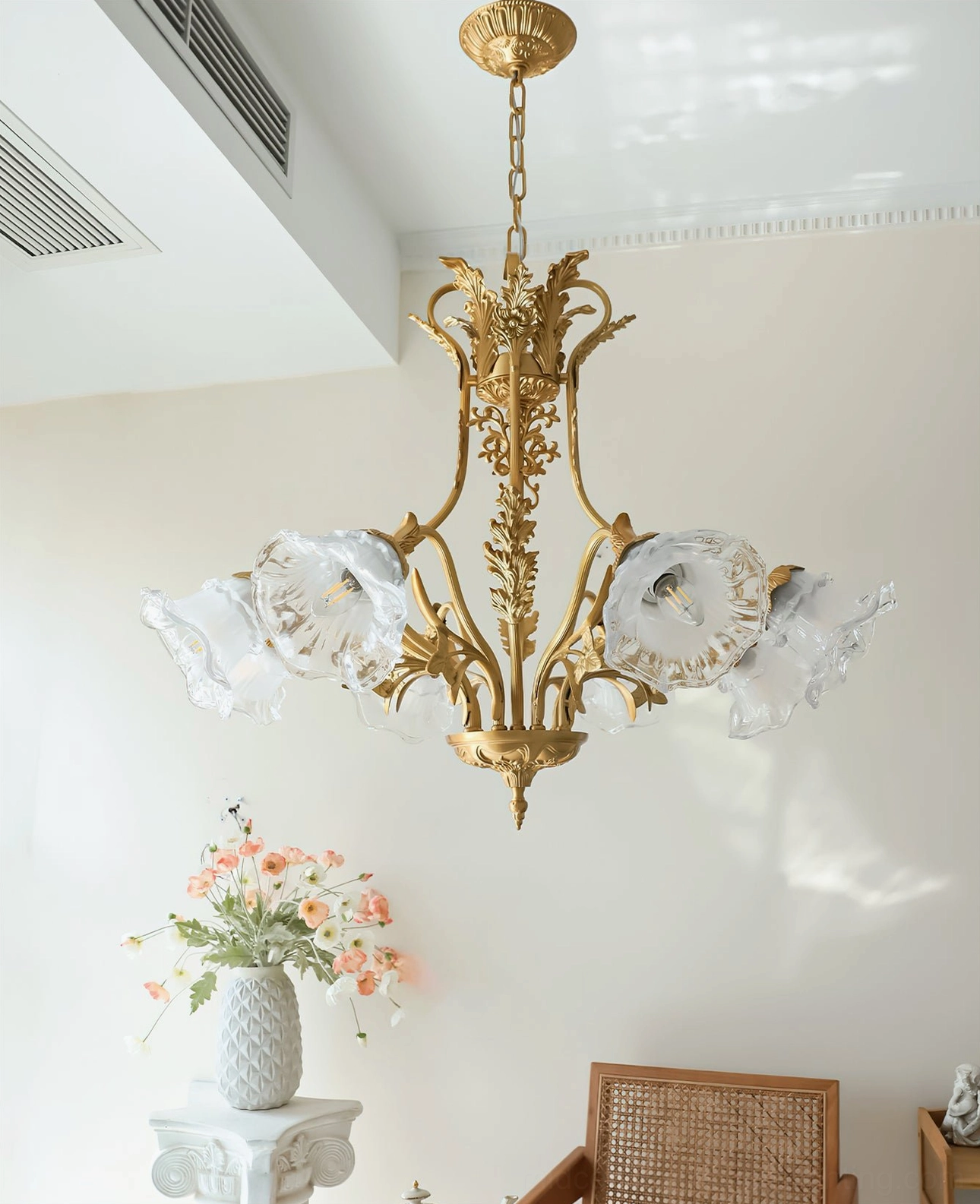 Unlit Dore flower chandelier against neutral backdrop showing sculptural brass arms and flower glass covers