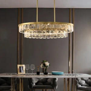 Luxury two-tier round crystal chandelier Doria hanging in upscale dining room interior with warm brass lighting